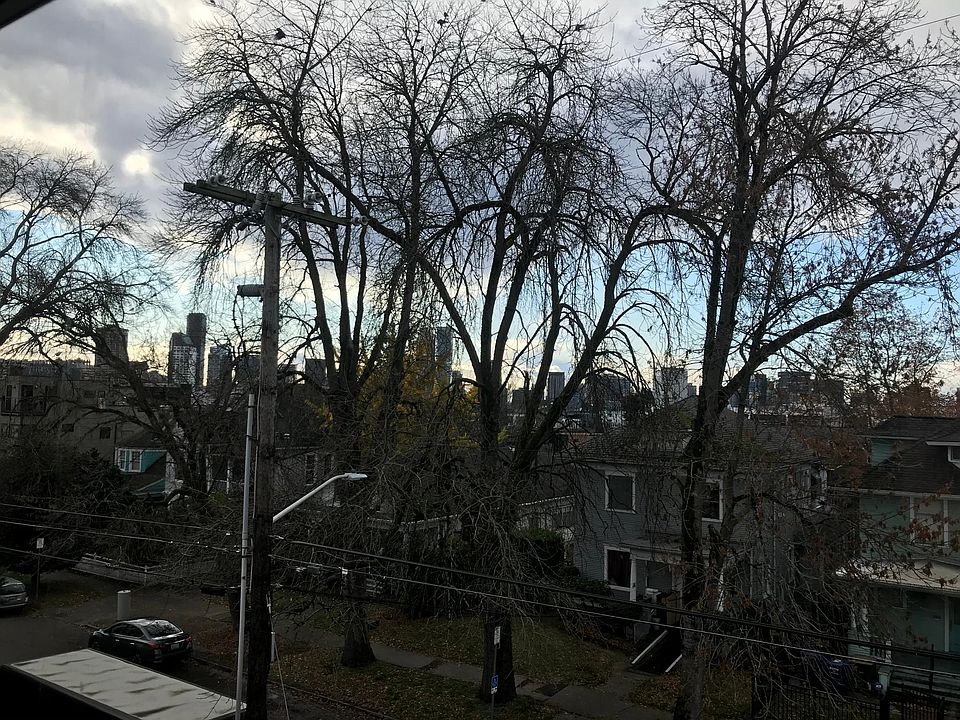 West facing living room window with view of Downtown, Space Needle, Puget Sound, and Olympic mountains
