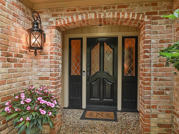 Warm and inviting entryway. Upgraded coach lamp, lead glass in the door and side windows. Your guests will immediately feel welcome as soon as they arrive to this charming porch. Sprinkler system also has a plastic tubing system that waters your flow