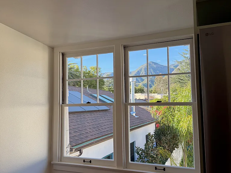 Dining nook next in kitchen with oversize windows