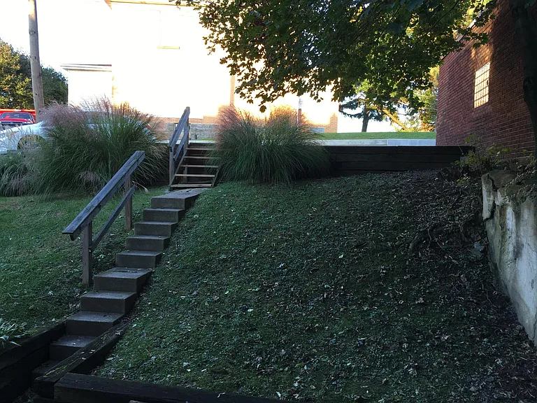 Back yard and steps to parking