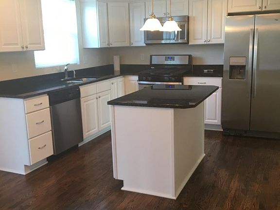 Granite counters, stainless appliances, and beautiful hardwood floors