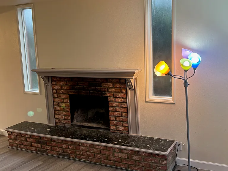 Brick fireplace against the living room wall