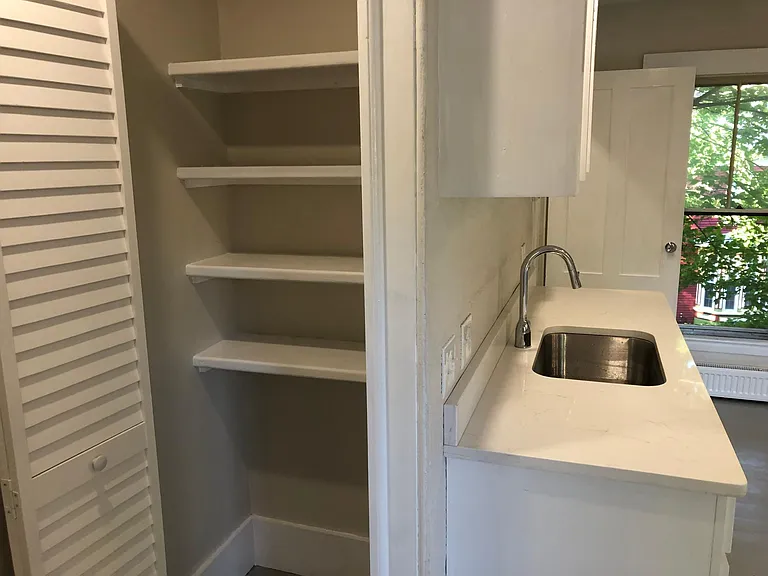 Pantry with lots of shelving.