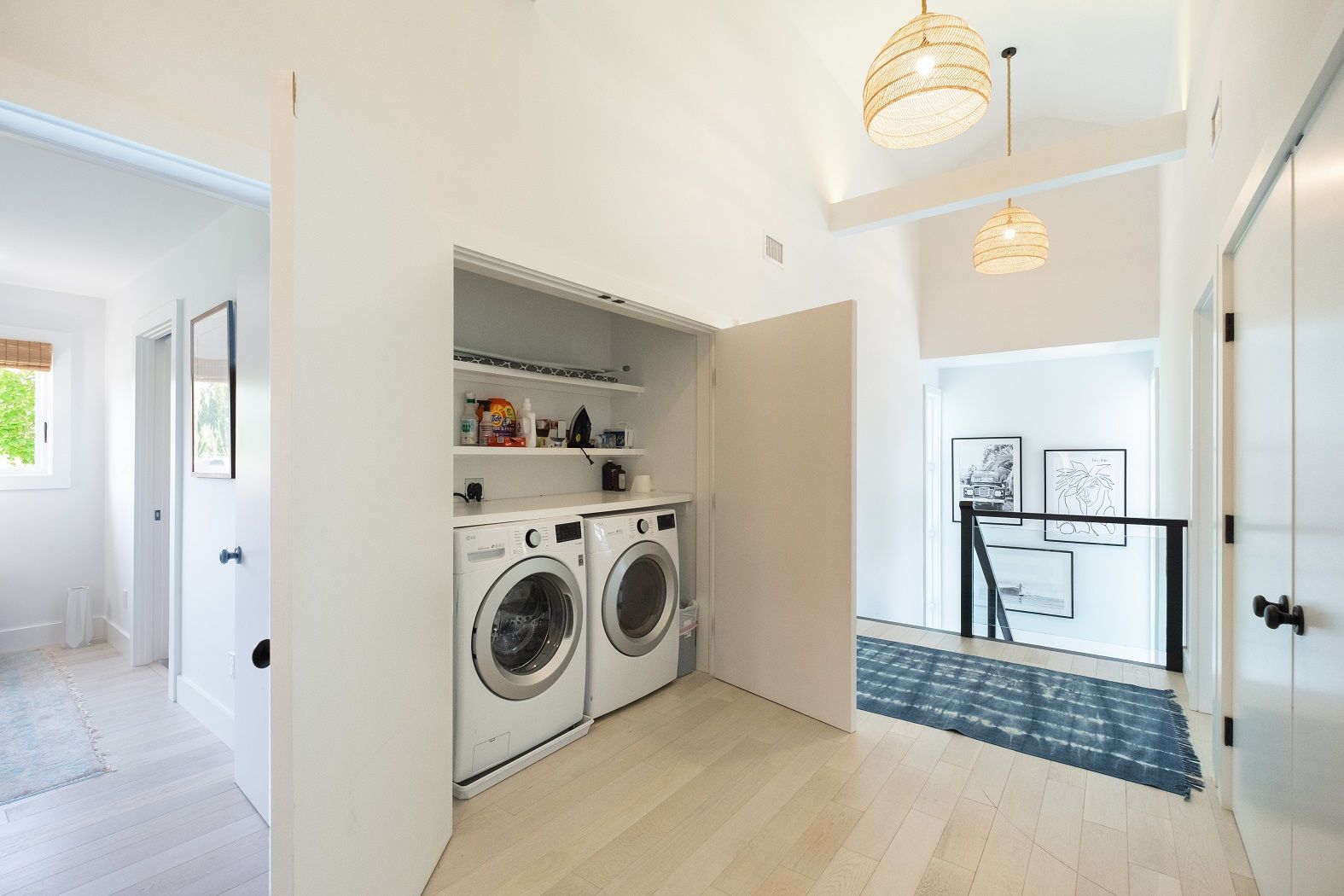 One of two laundry rooms fully stocked with large capacity washer and dryer