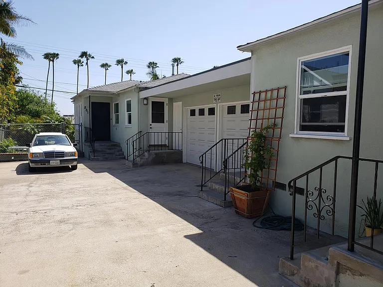 View of driveway, 861 in the back, and garages.