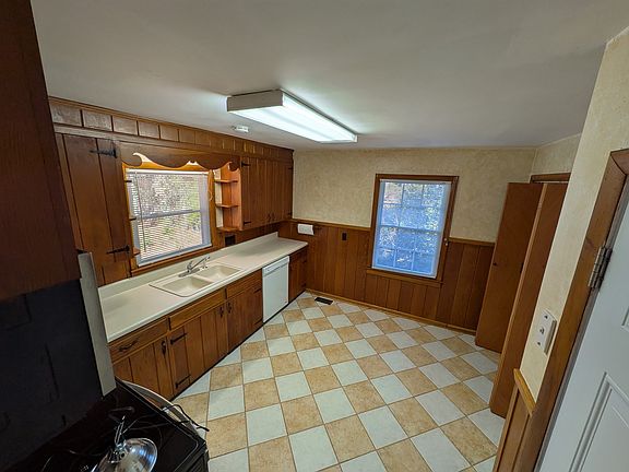 Kitchen with dishwasher, fairly new (2024) stove and microwave, and side-by-side refrigerator with icemaker