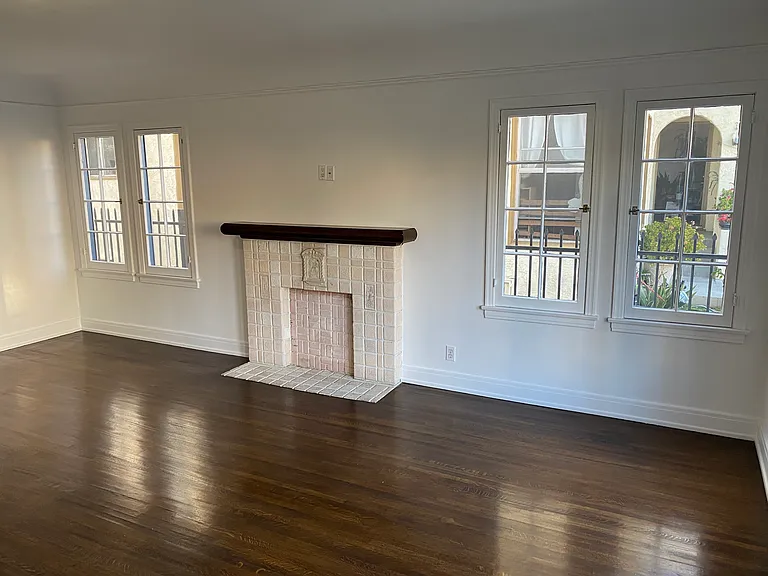 Living Room with Vintage Faux Batchelder Fireplace and Medium Stained Original Oak Hardwood Floors