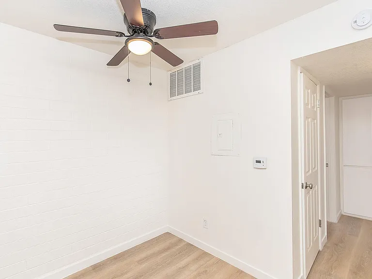 Room, hardwood floors, ceiling fan, built-in storage