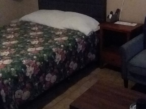 Double size bed with wall heater and night stand