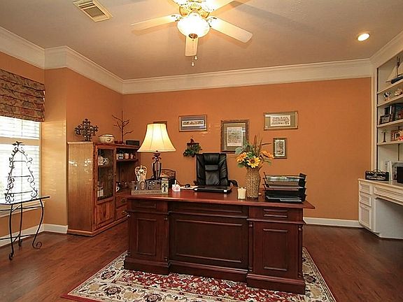 Hardwoods are also in the big study with a wall of built-ins