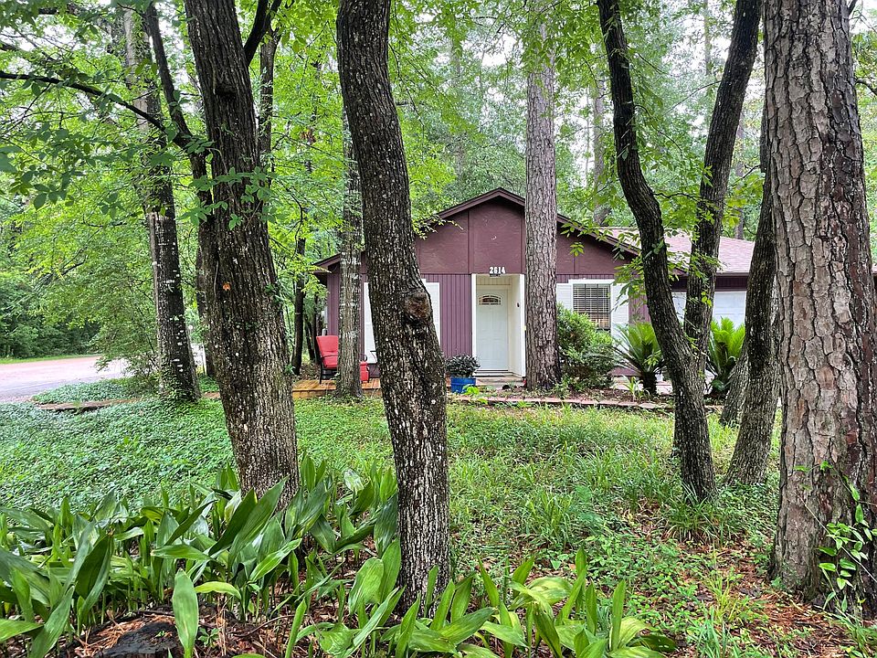 Lush landscape surrounds the home that sits on the corner of a cul-de-sac street.