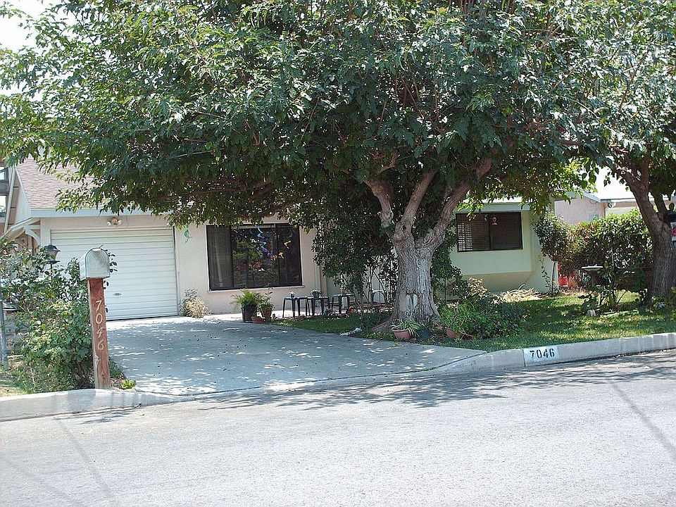 Front of home with shady mulberry and tangerine trees