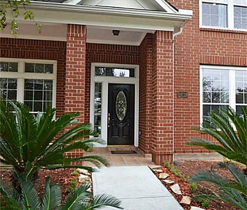 Inviting covered entry with freshly laid concrete walk way!