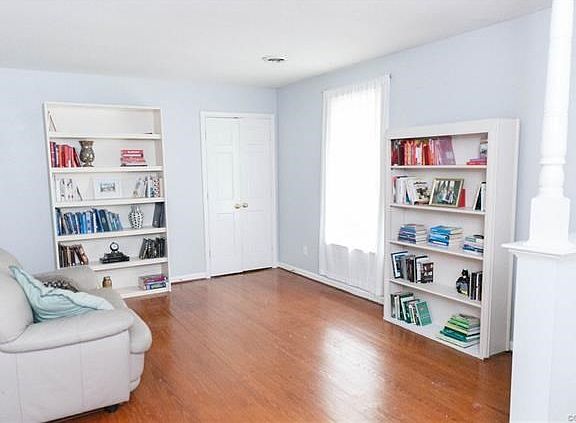 Formal living room with doors leading to the family room.