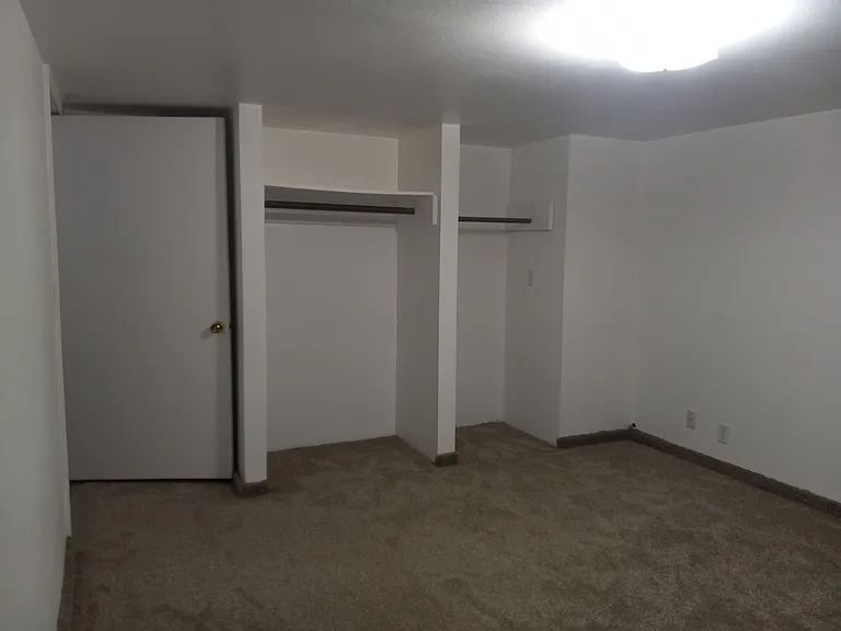 View #2 of first bedroom. Shows his & hers closets