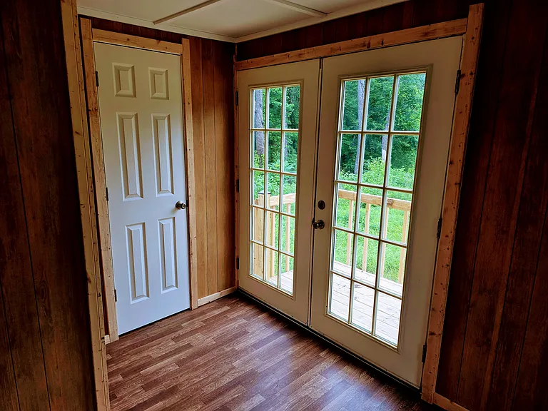 Bedroom closet and French doors to deck and yard.