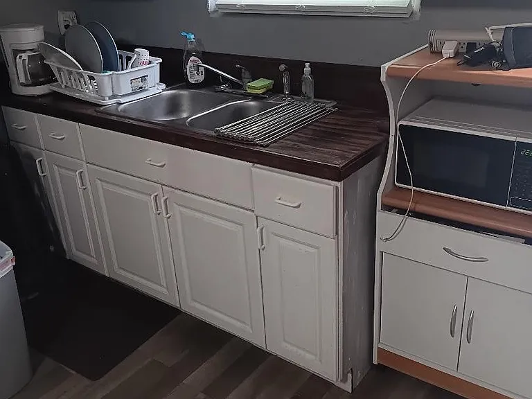 kitchen has microwave, oven, toaster oven and new refrigerator