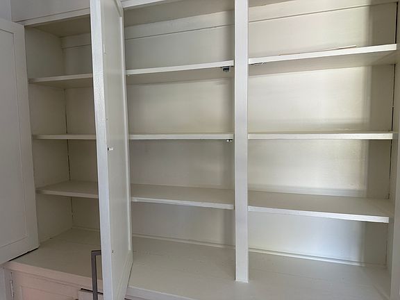 A wall of kitchen storage cabinets.