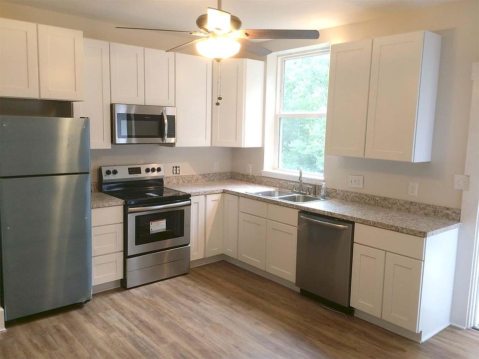 Sunny modern kitchen with access to back deck. Plenty of room to add a table.