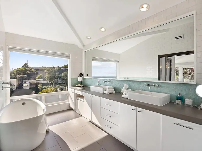 Enjoy luxury in our master bathroom, featuring a deep Bisazza tiled bathtub, double-sided showers, freestanding soaking tub, custom cabinetry, and premium toiletries.