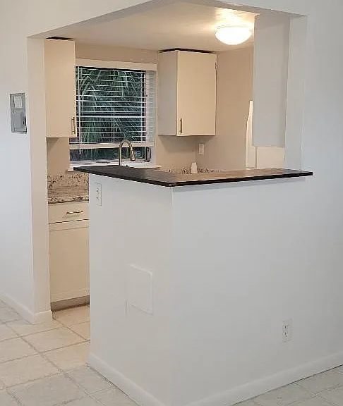 Another view of breakfast bar & kitchen.