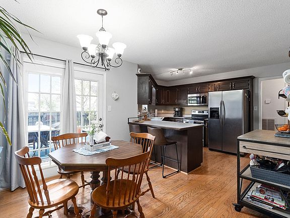 dining area and kitchen with stainless steel appliances