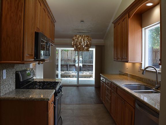 Remodeled kitchen with granite counter tops & oak cabinets
