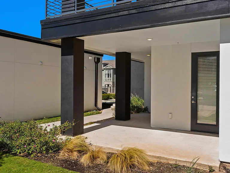 Ground-Level Outdoor Patio Space with Walkway Access at Rhythm Apartments