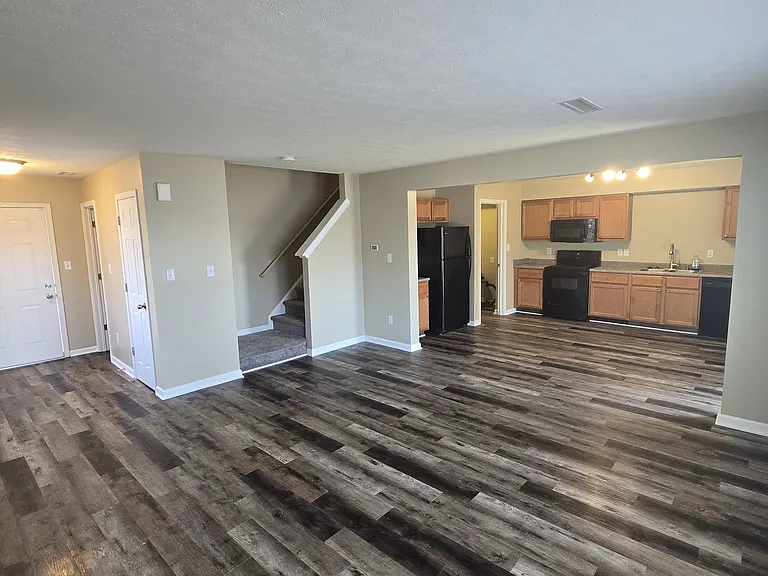 Living Room showing Entryway, stairs, and kitchen