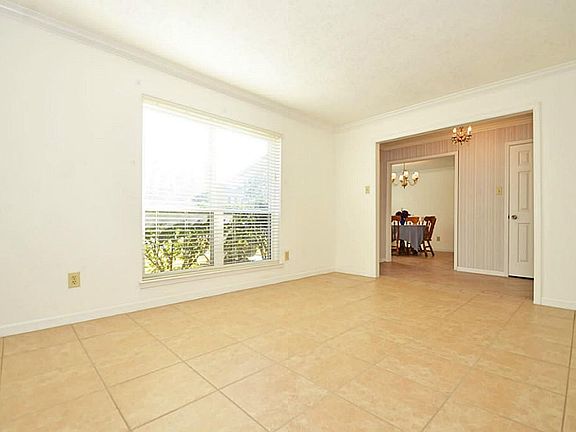 Large Formal Living Room with Wood Blinds is located off the Entry Foyer (could be study or playroom