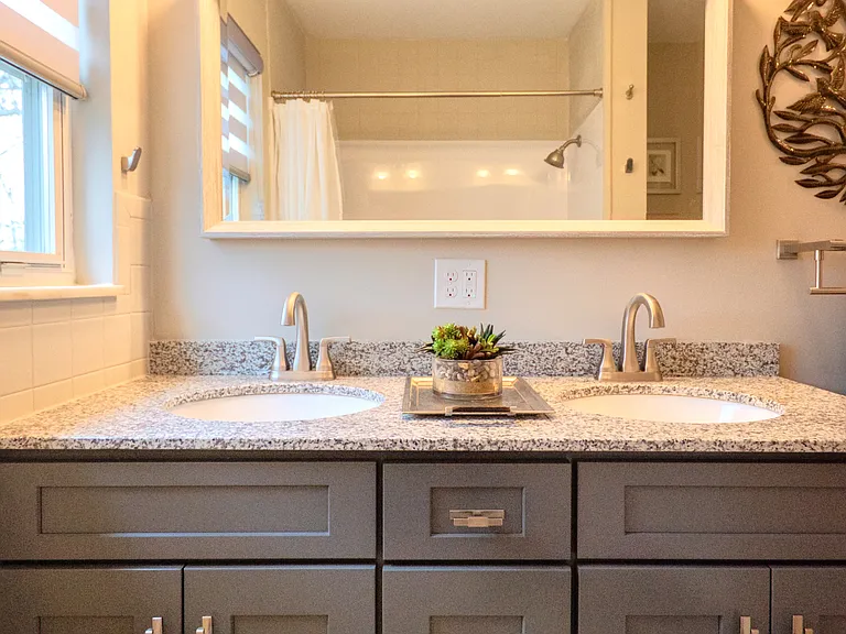 En suite bathroom with double sink vanity and plenty of storage