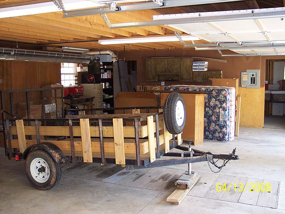fully functional garage equipped with exhaust fan and air compressor lines,