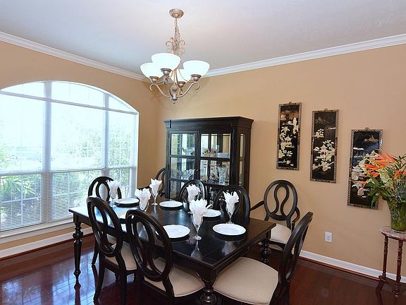 The dining room is spacious and features hardwood floors and crown molding.