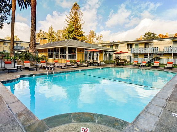 Outdoor swimming pool area with lounge seating.