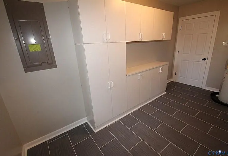 HUGE Laundry room w/ built-in storage cabinets located off the kitchen
