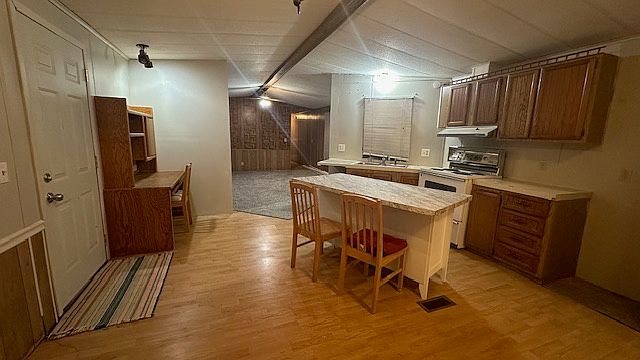 Open Kitchen with Island and desk with ample eating area