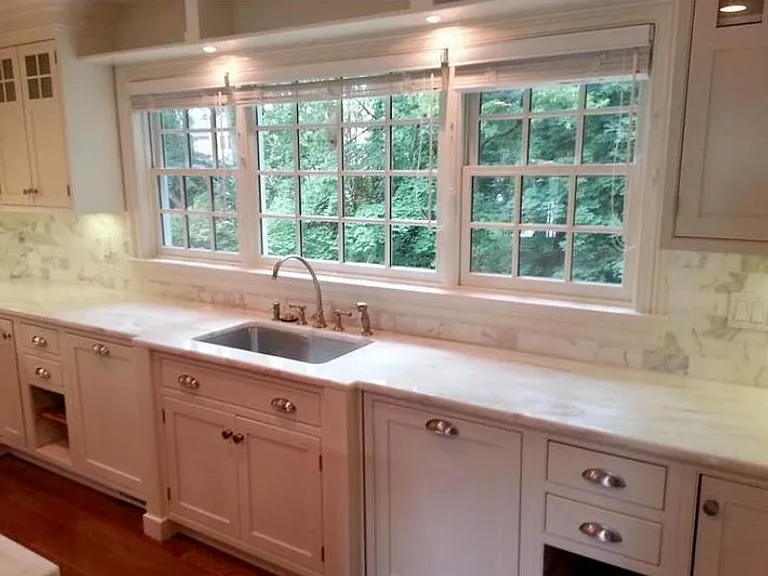 Marble countertops; brushed nickel fixtures; lots of cabinets and drawers. Windows look out to creek.