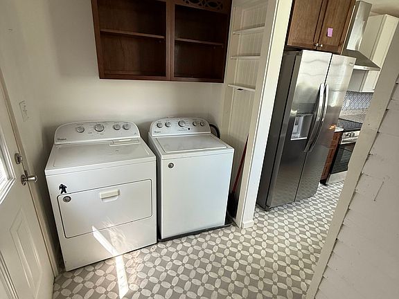 Laundry and storage room with large deck out back door.