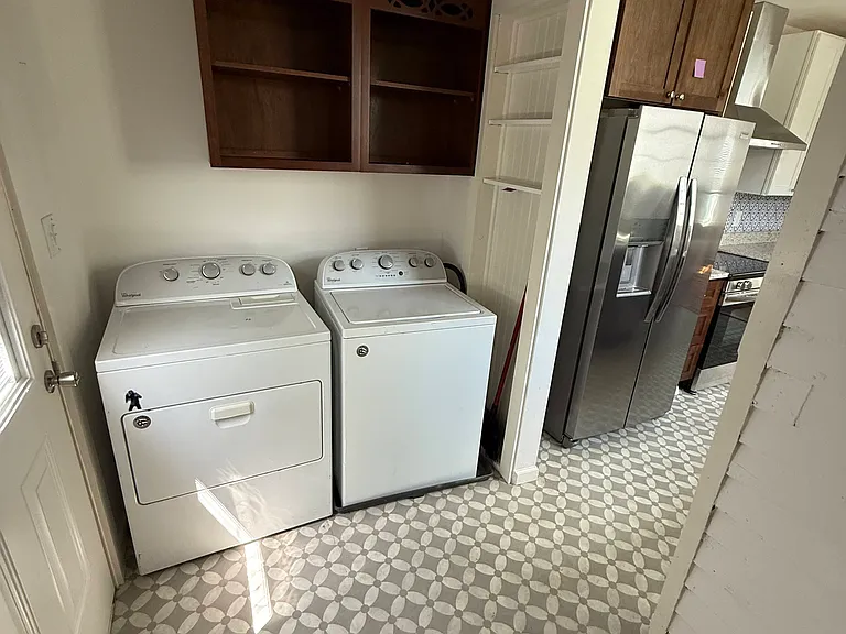 Laundry and storage room with large deck out back door.