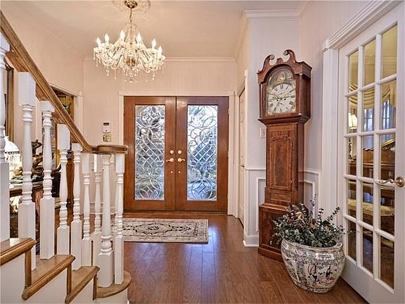 The double doors open to the welcoming foyer.