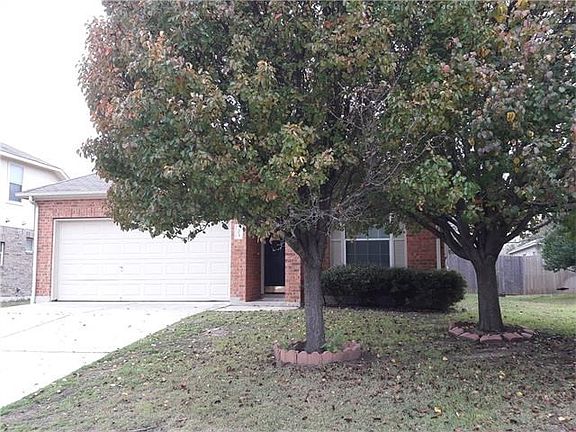 Nicely maintained brick home on a quiet street. Trees give s