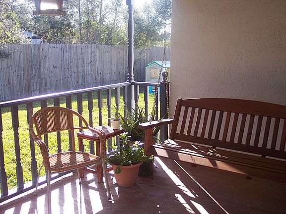 relaxing back porch with bench swing