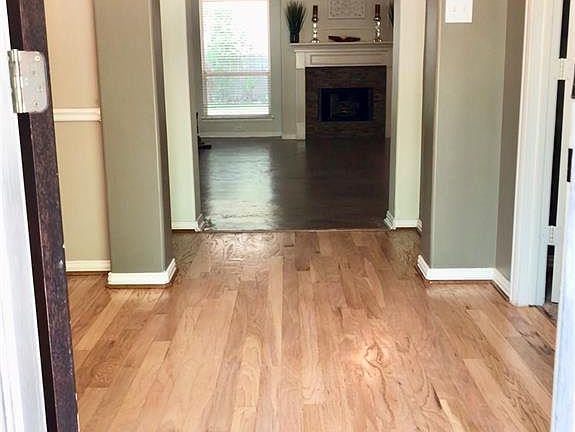 HARDWOOD FLOORING IN DINING ROOM AND FOYER REFINISHED TO THIS PRETTY LATTE SAND COLOR!