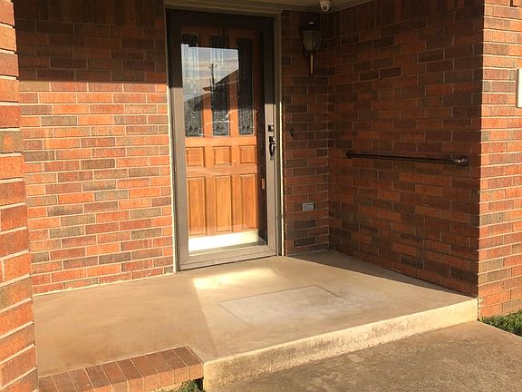 Covered front porch with nice seating area.