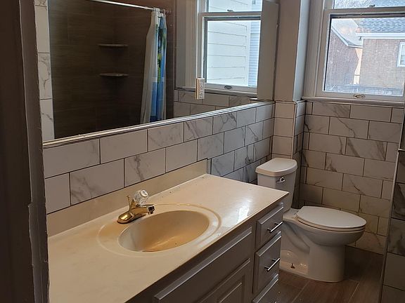 good sized bathroom with window shade not shown