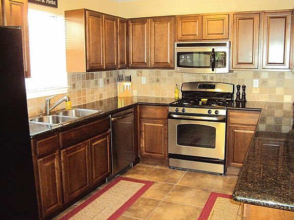 Updated kitchen offers Granite counters, tumbled Travertine backsplash, stainless steel appliances a