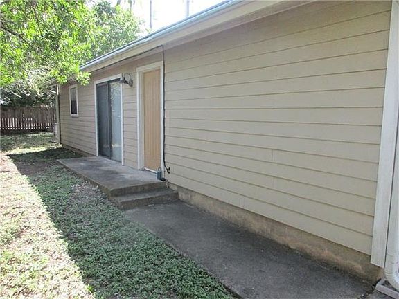Front door is behind private fenced yard.