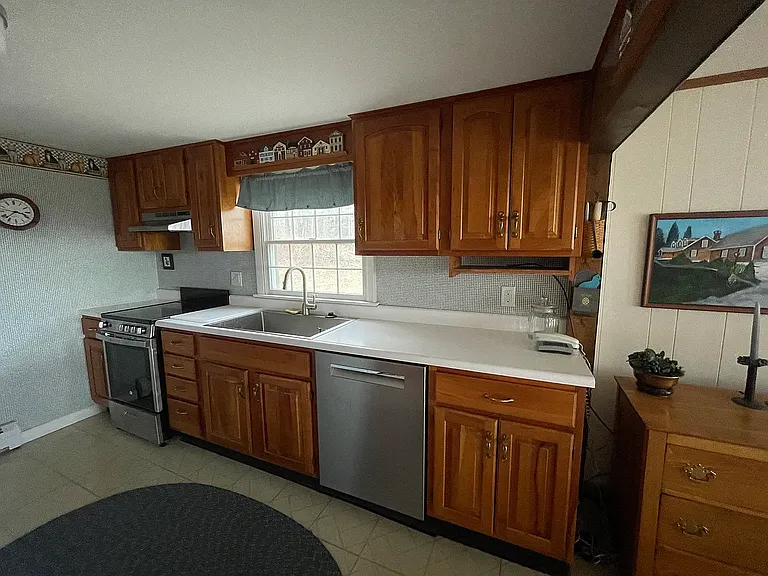 Kitchen with new stainless steel range, large sink, and 800 series Bosch dishwasher