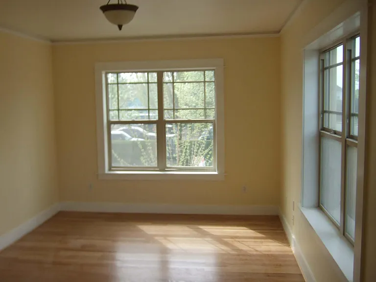 Four large windows in main living room, with eastern and southern views, provide tons of natural light. Gleaming hardwood floors throughout.