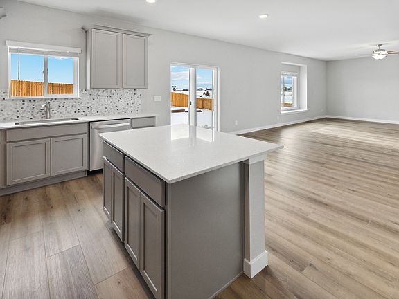 The dining room and living room sit adjacent to the kitchen for easy family living.